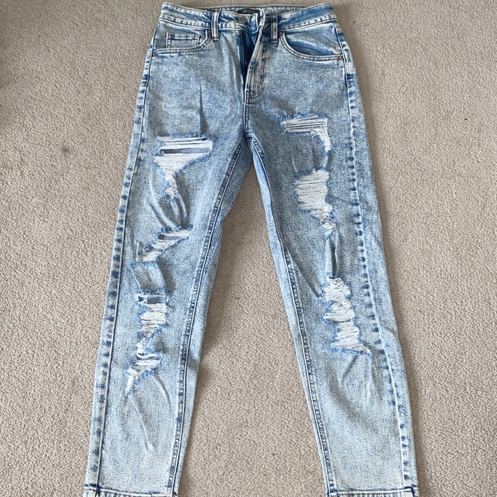HARDLY WORN: high rise ripped mom jean.